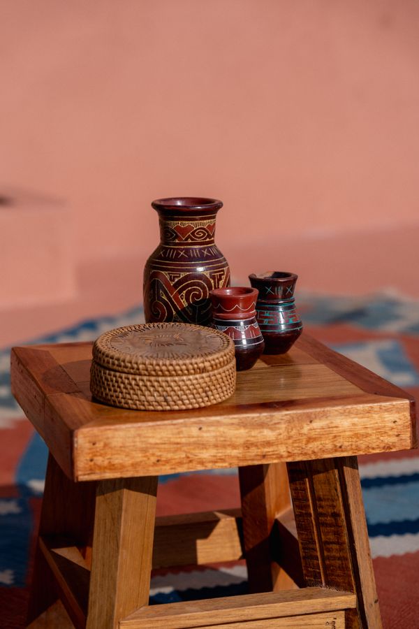 Small vases and a lidded box on a wooden stool