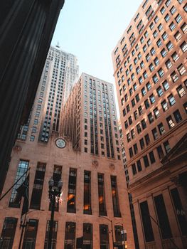 Low-angle view of skyscrapers in the Chicago Loop, showcasing urban architecture and city life.