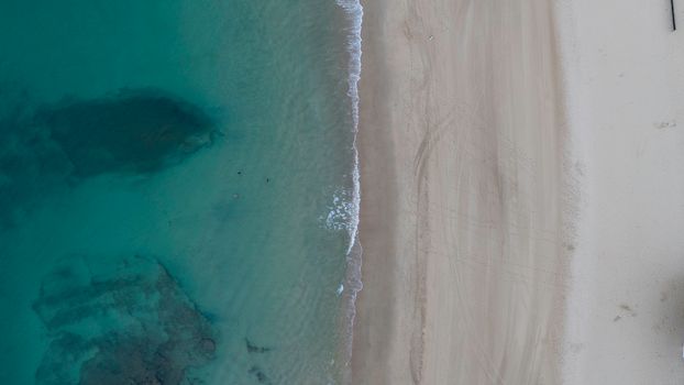A stunning aerial view of Caloundra Beach with turquoise waters and sandy shore.