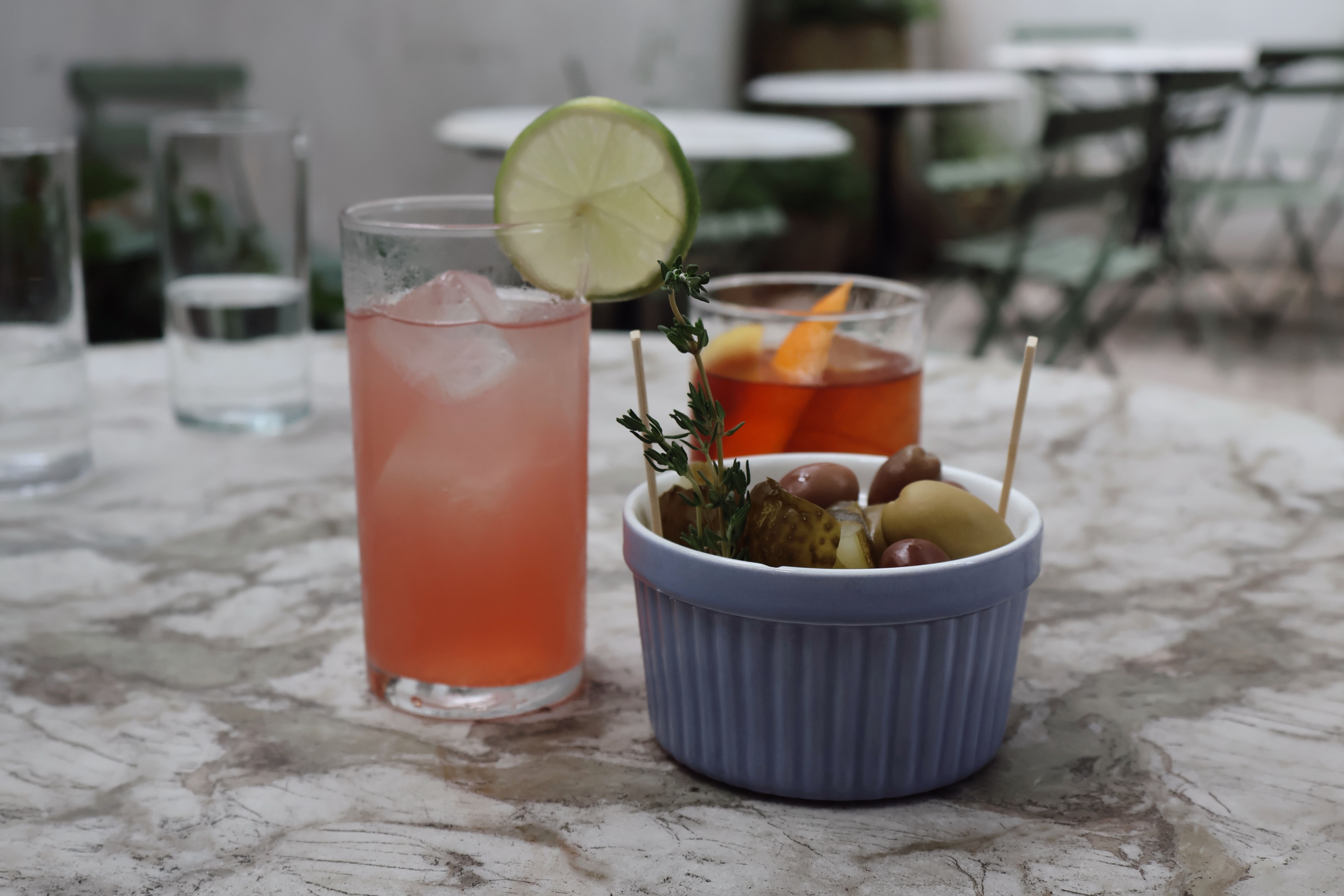 Iced drinks and small snacks set out on a clinic-adjacent cafe table