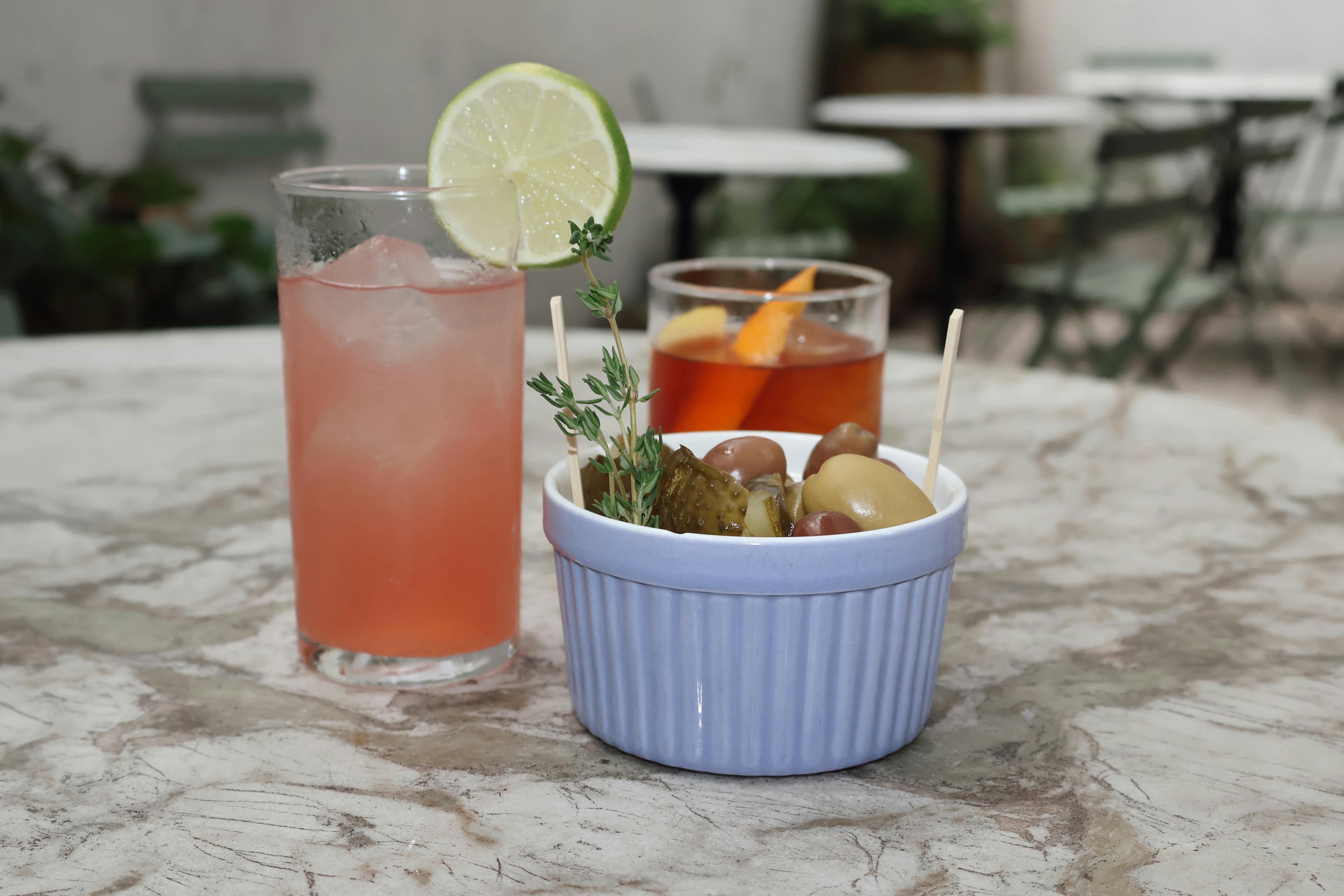 A selection of cocktail garnishes, including citrus wedges and olives - cocktail perfection tools