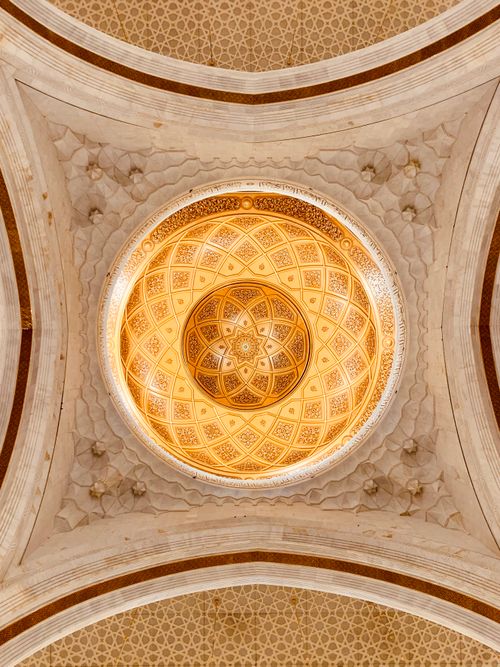 Free Intricate interior of a mosque in Makkah showcasing an ornate dome ceiling with Islamic patterns. Stock Photo