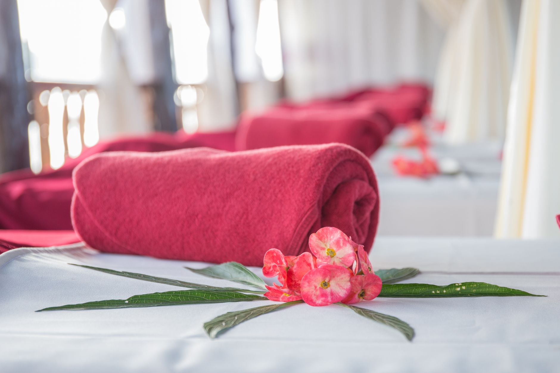 Affordable Massage Spa Near Me in Nairobi CBD 2 Elegant spa interior featuring red rolled towels and vibrant flowers, perfect for relaxation.