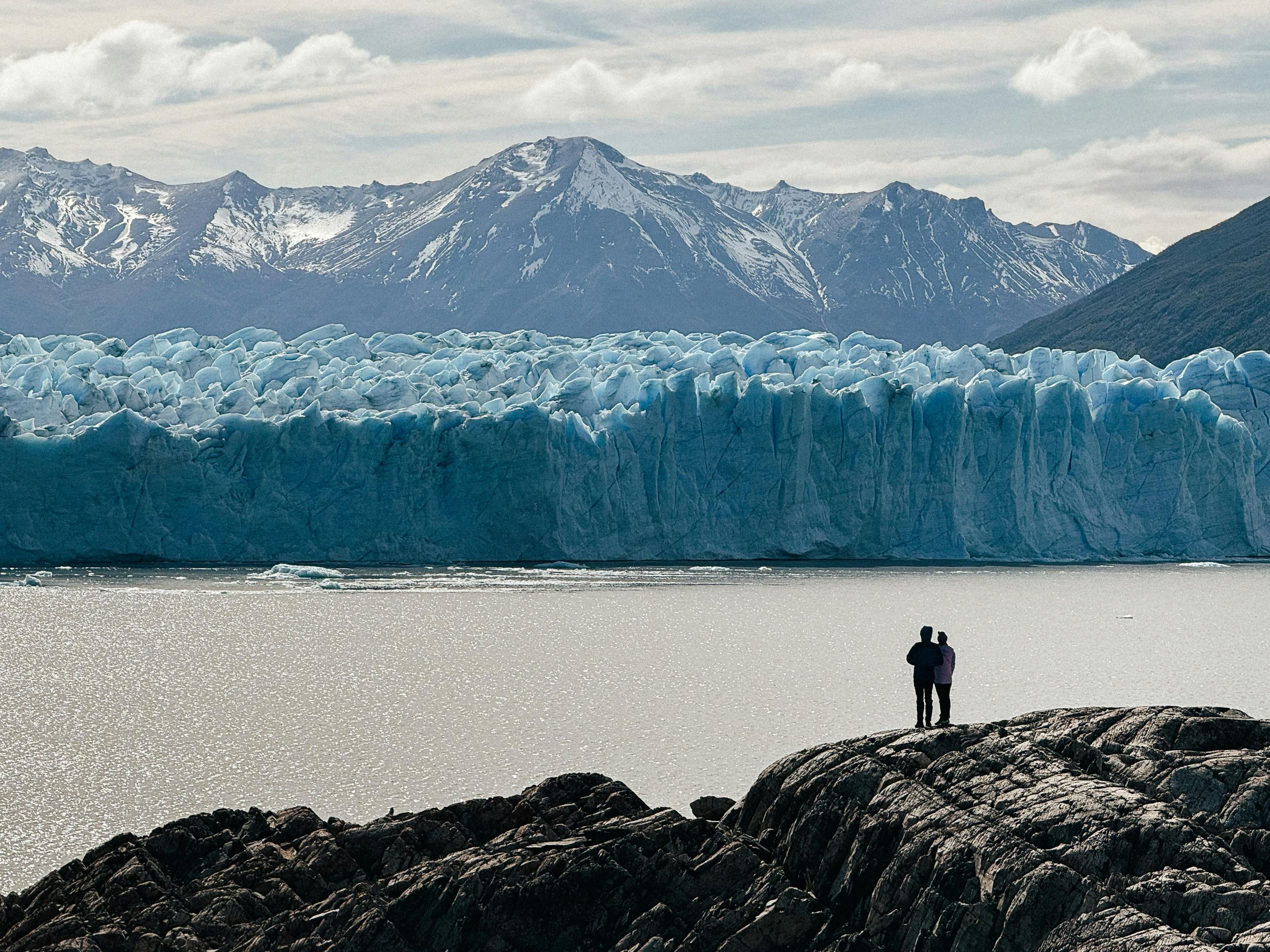 Couple hiking in Patagonia, Argentina, with a travel insurance card visible