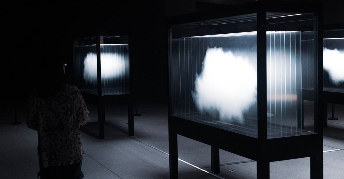 Rüyada Hiçliğe Düşmek - Rüya Tabiri ve Anlamı - Abstract cloud display in a dimly lit room with a silhouette of a person watching.