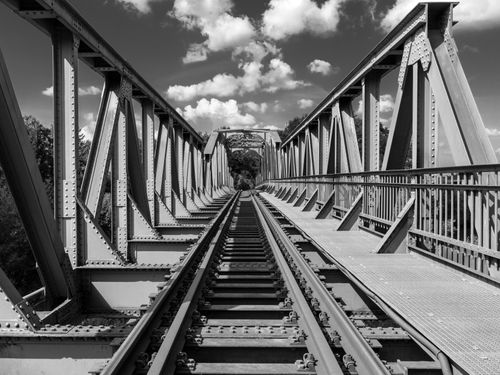 Free A striking black and white photo of a steel railroad bridge in Winsen, Germany. Stock Photo