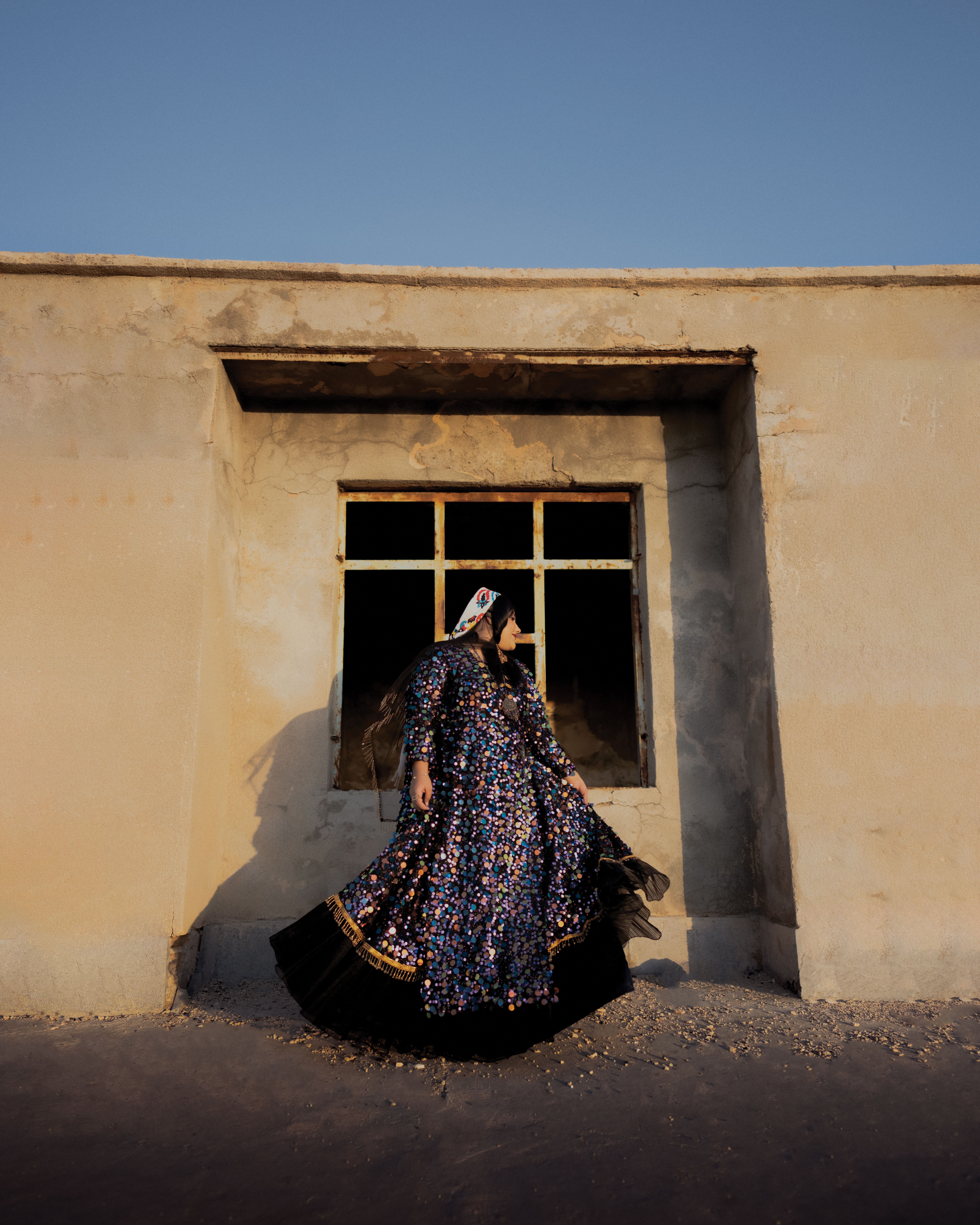 A Woman in a Dress Standing in Front of a Building · Free Stock Photo