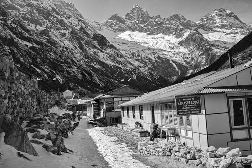 Free Scenic view of a Himalayan village in Nepal with snow-capped mountains in black and white. Stock Photo