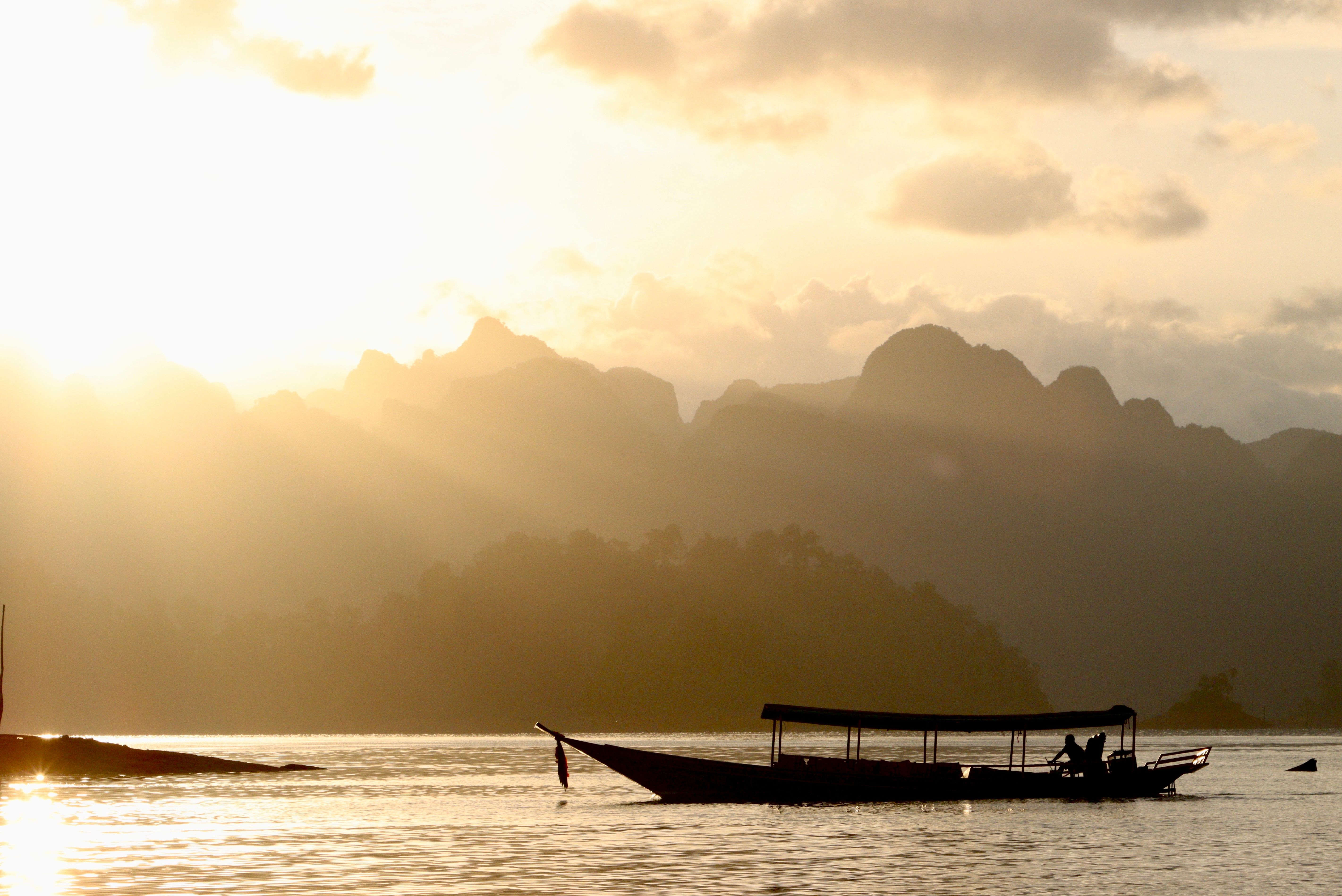 Sunlight over Motorboat on Lake at Sunset · Free Stock Photo