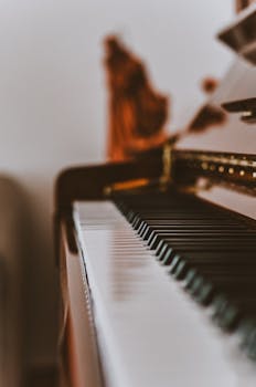 Close-up view of piano keys in a soft-focused, artistic composition indoors.