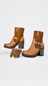 Tan leather ankle boots on a studio pedestal — José Martin Segura Benites on Pexels