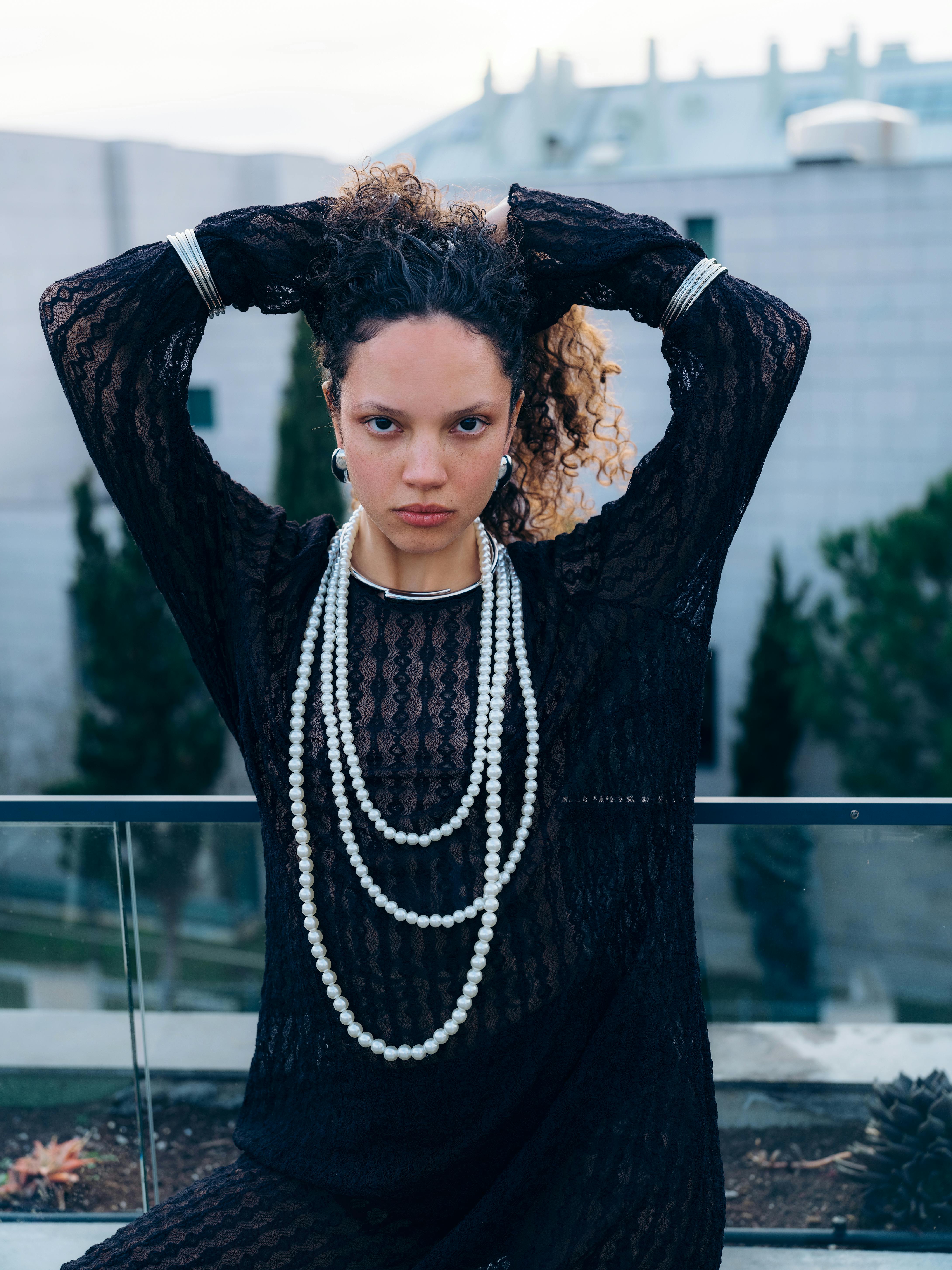 Stylish portrait of a woman in black lace and pearls, captured in Lisbon.