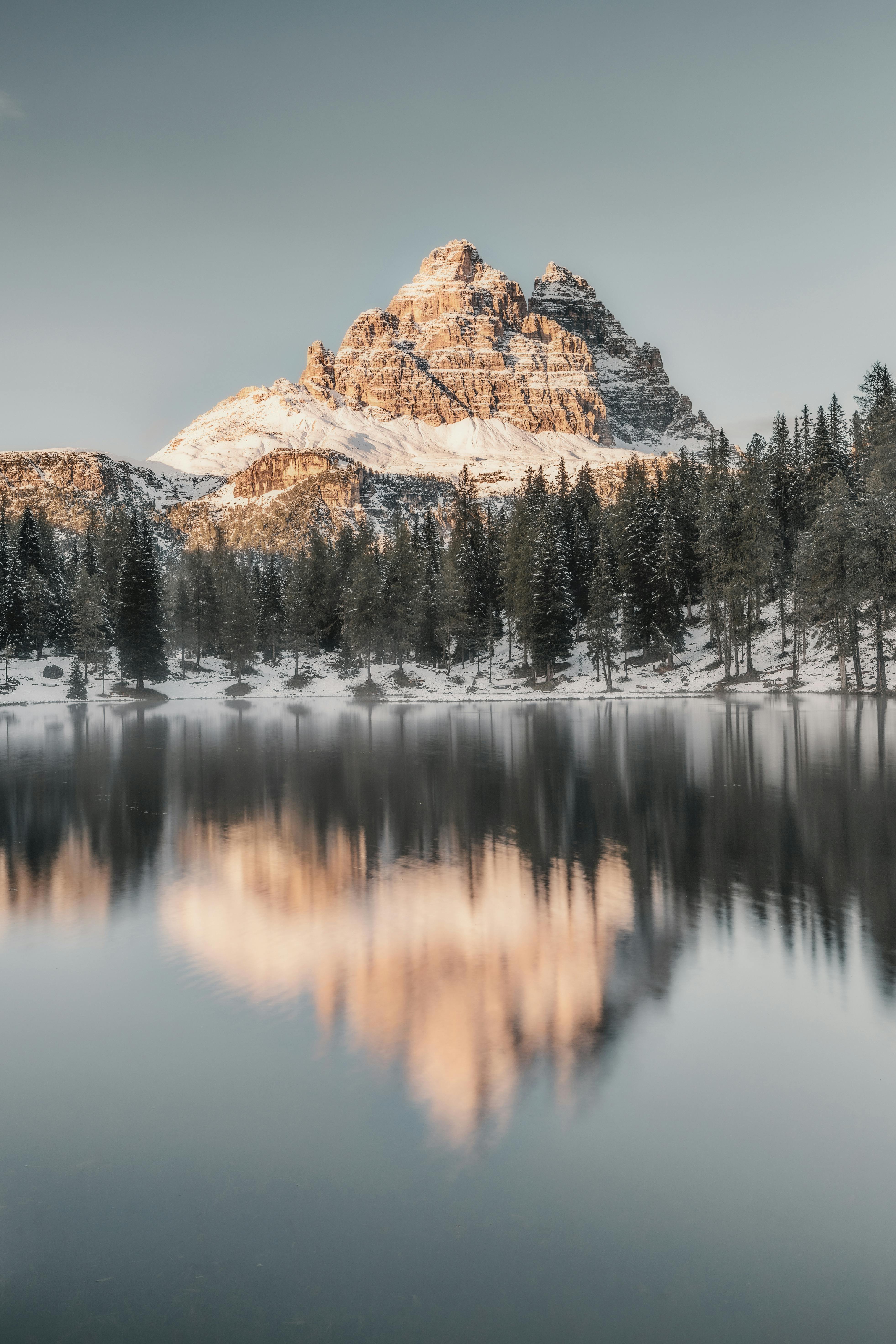 Stunning winter landscape with Mount Tre Cime reflected in Lake Antorno, Italy.