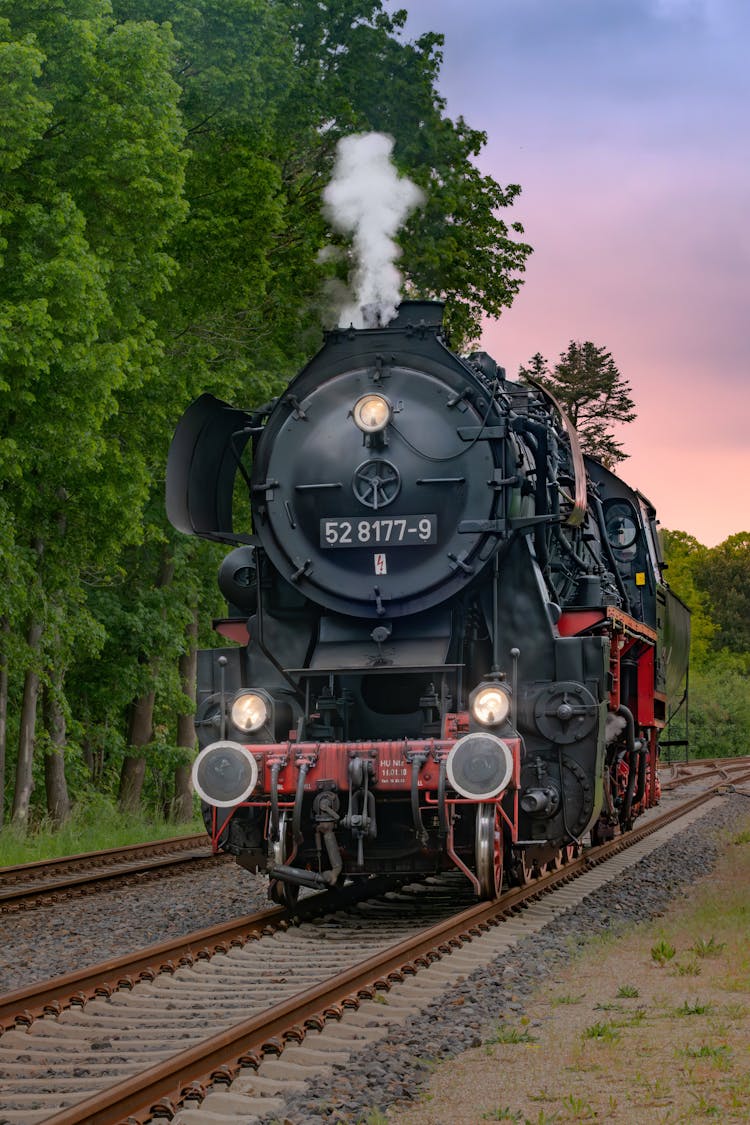 Steam Locomotive On Railway At Dusk