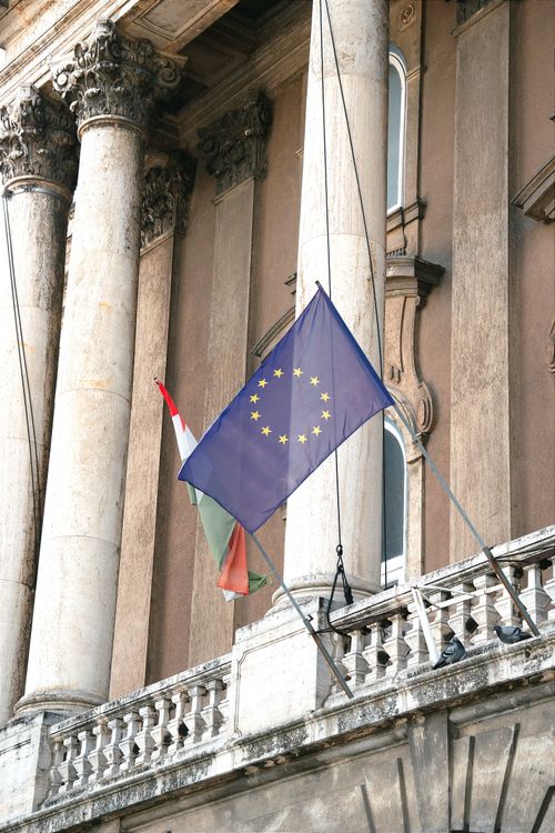 Free Flags of European Union and Hungary displayed on a historic building facade in Budapest, Hungary. Stock Photo