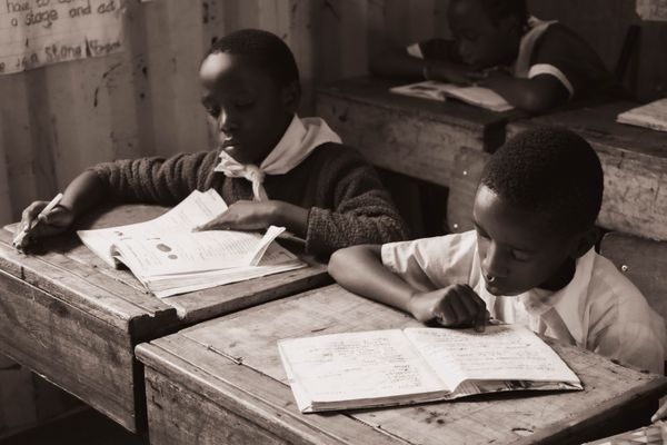Boys reading together at school