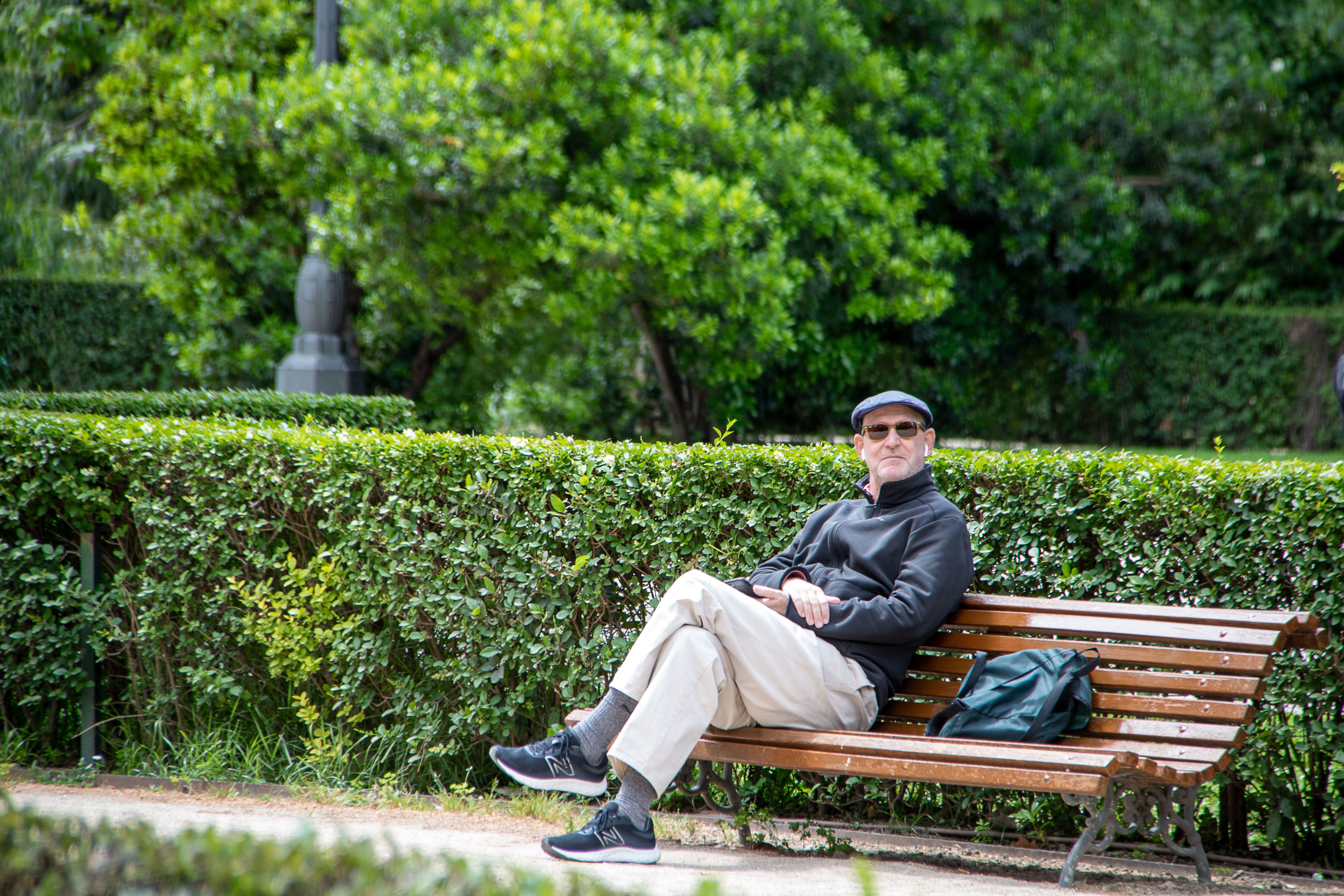 Man Sitting on Bench at Park · Free Stock Photo