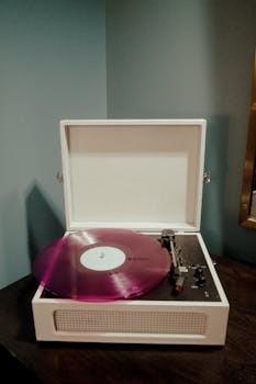 A stylish vintage turntable playing a vibrant purple vinyl record indoors.