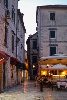 Discover the quaint atmosphere of Kotor's historic old town with cozy restaurants and ancient architecture.