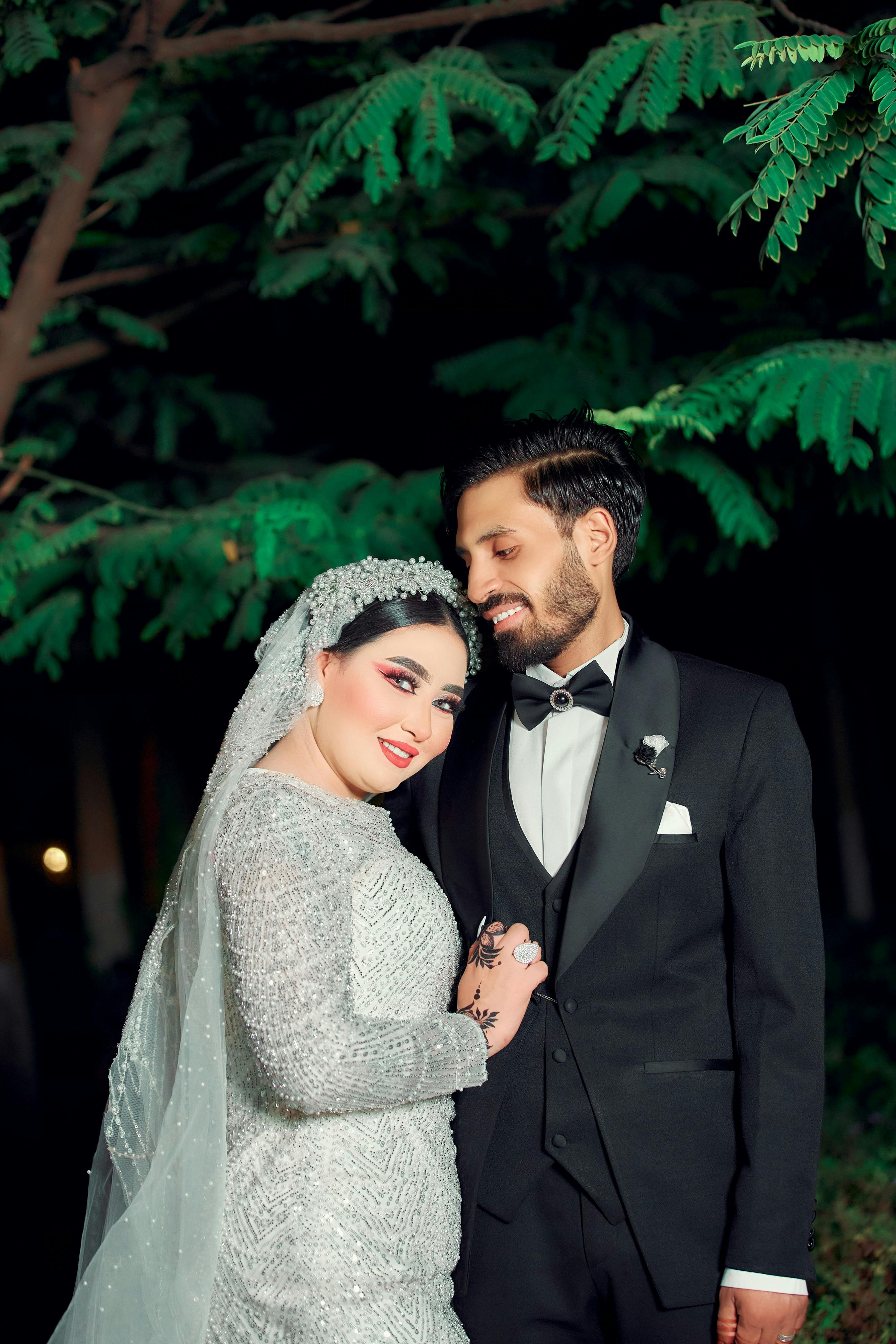 portrait of newlyweds standing together at night