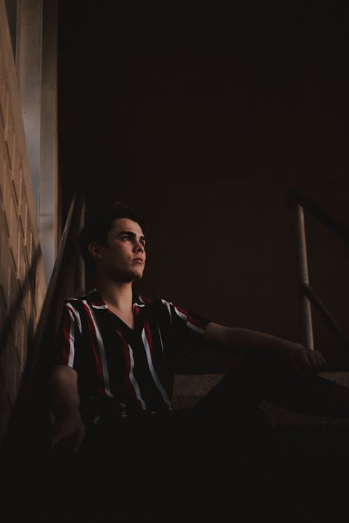 Photo of Man Sitting on Stairs