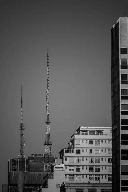 Free Black and white photo of urban skyline with communication antennas and modern buildings. Stock Photo