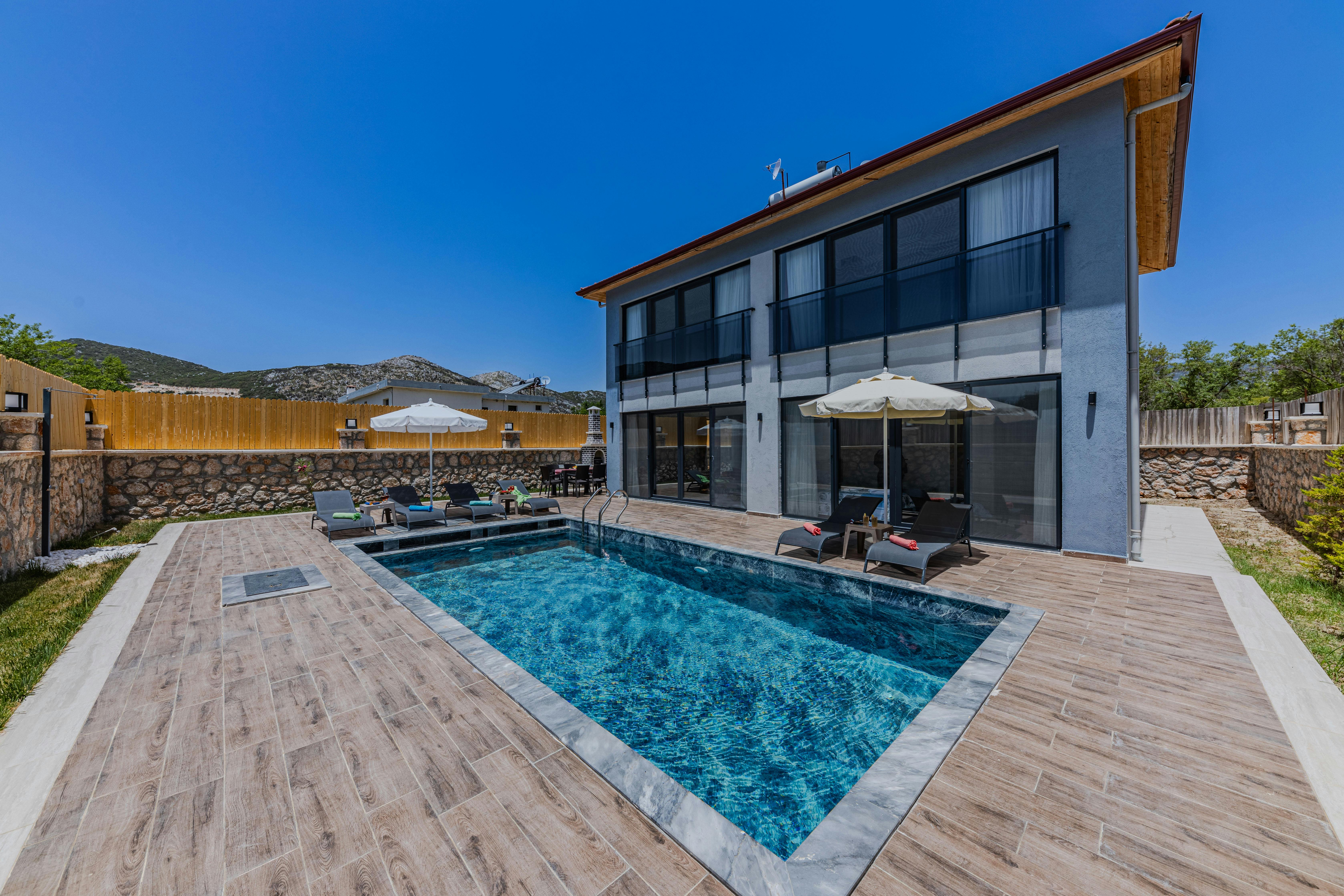 view of a luxurious villa with a swimming pool