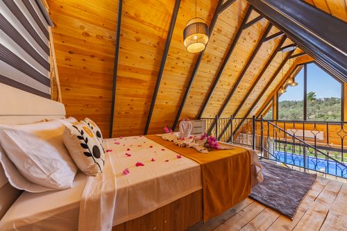 Free Warm and inviting loft bedroom with decor for a romantic getaway. Stock Photo