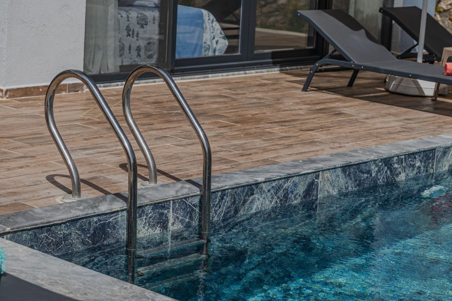 Pool decking in McAllen with stone edging and patio surface