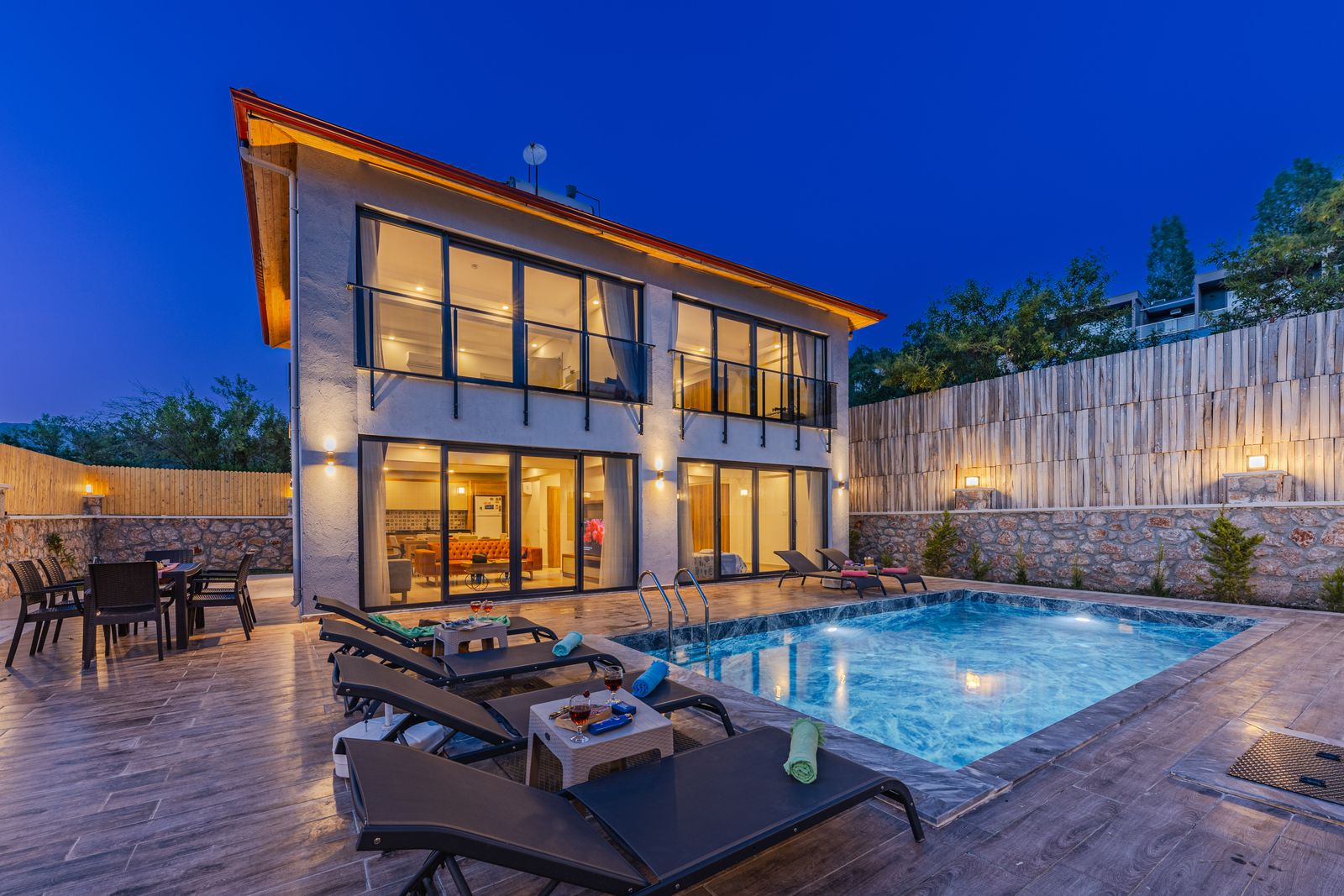 Modern residence with pool glowing at twilight