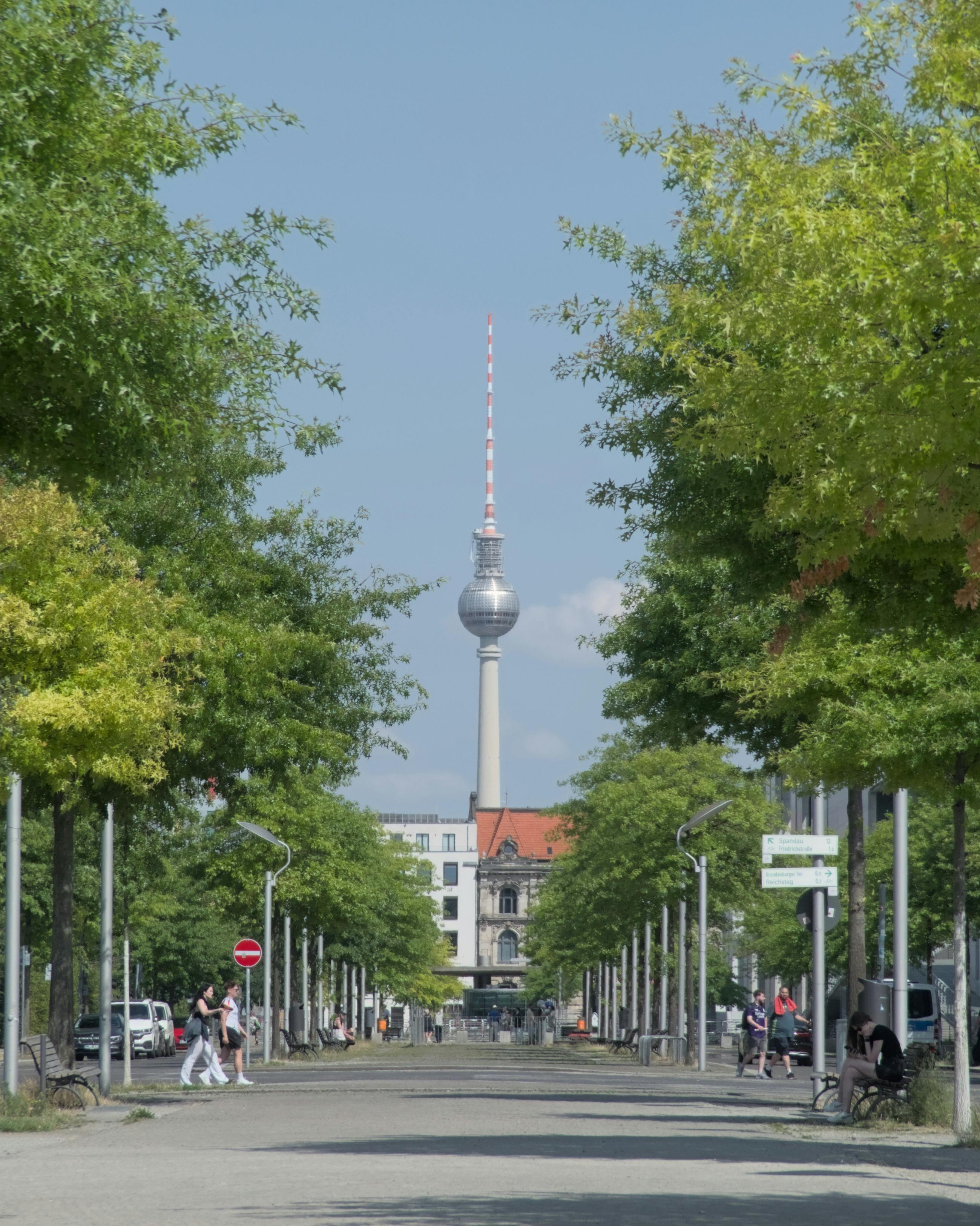 People Walking On A Street In Berlin Near Zeughaus With The TV Tower In people-walking-on-a-street-in-berlin-near-zeughaus-with-the-tv-tower-in