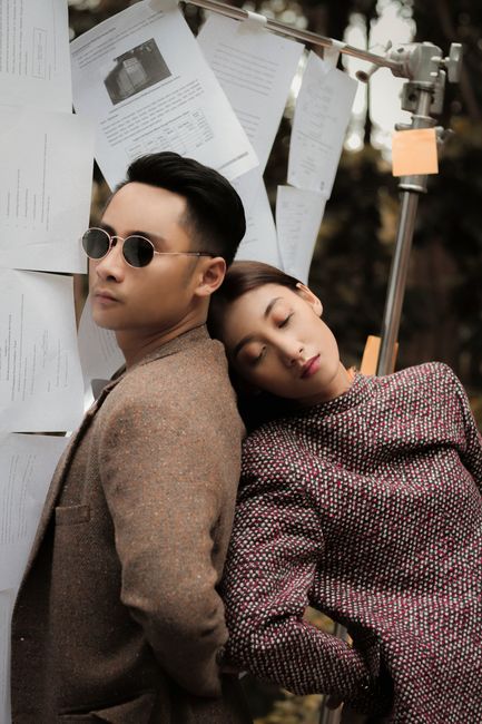 Chic outdoor fashion portrait of a man and woman posing with stylish outfits.