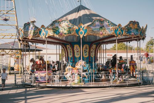 Free Charming vintage carousel at a daytime fairground, perfect for leisure and entertainment. Stock Photo