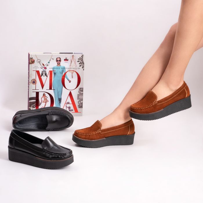 Stylish brown and black moccasins with a fashion book and model in a studio setup. — photo by José Martin Segura Benites on Pexels