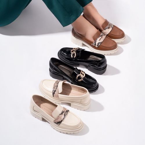 Free Stylish women's loafers showcased in a studio shoot with a white background. Stock Photo
