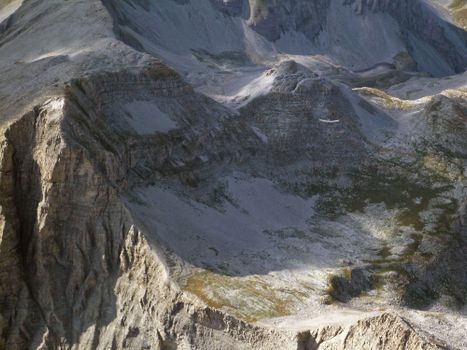 A breathtaking aerial view of the rocky mountains in Prads-Haute-Bléone, France, showcasing dramatic formations.