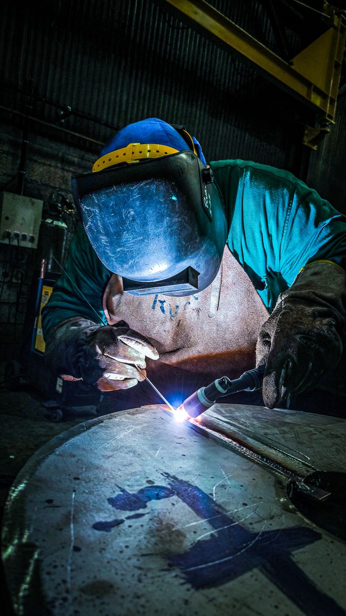 Industrial welder representing skilled trades industry