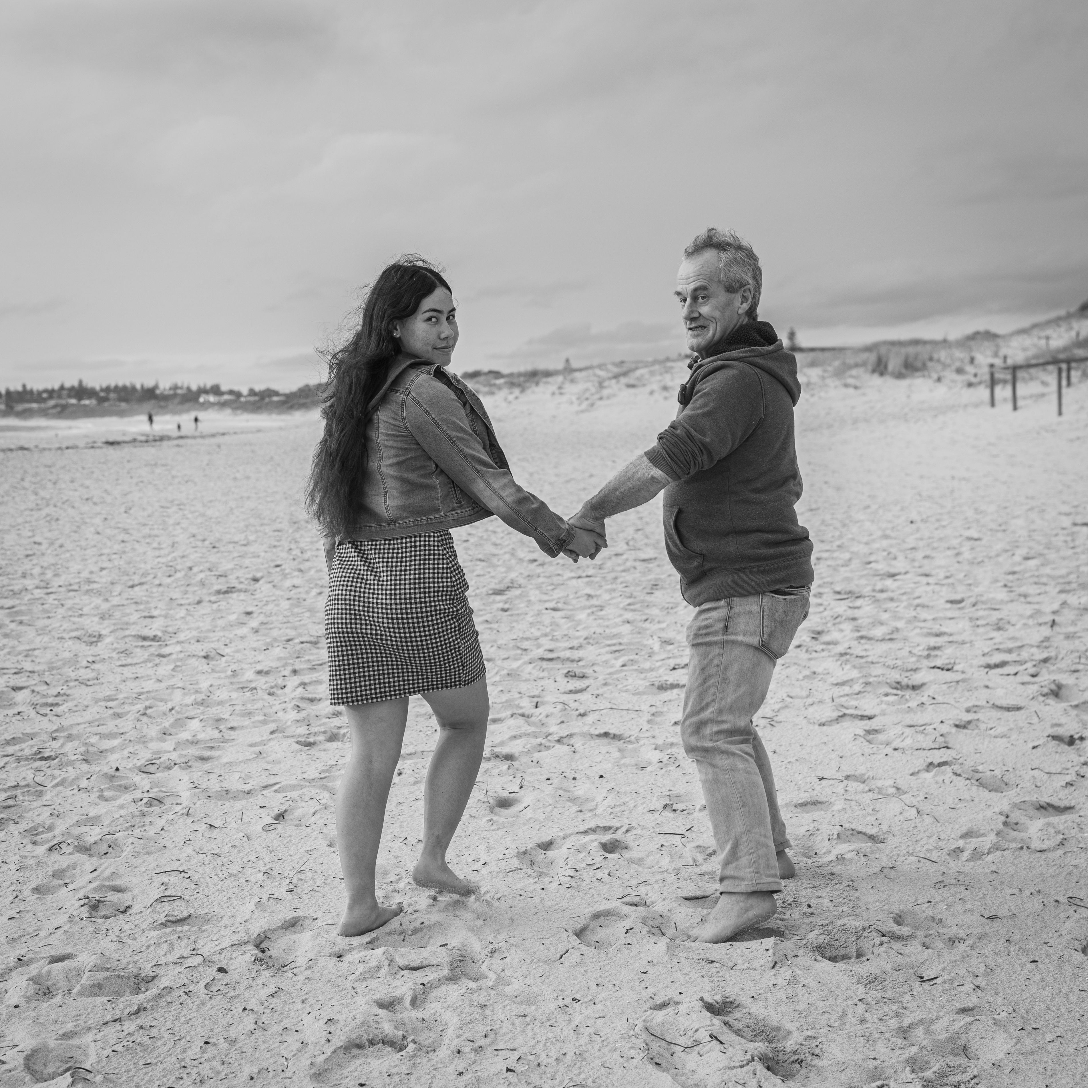 Black and white photo of couple holding hands on beach · Free Stock Photo