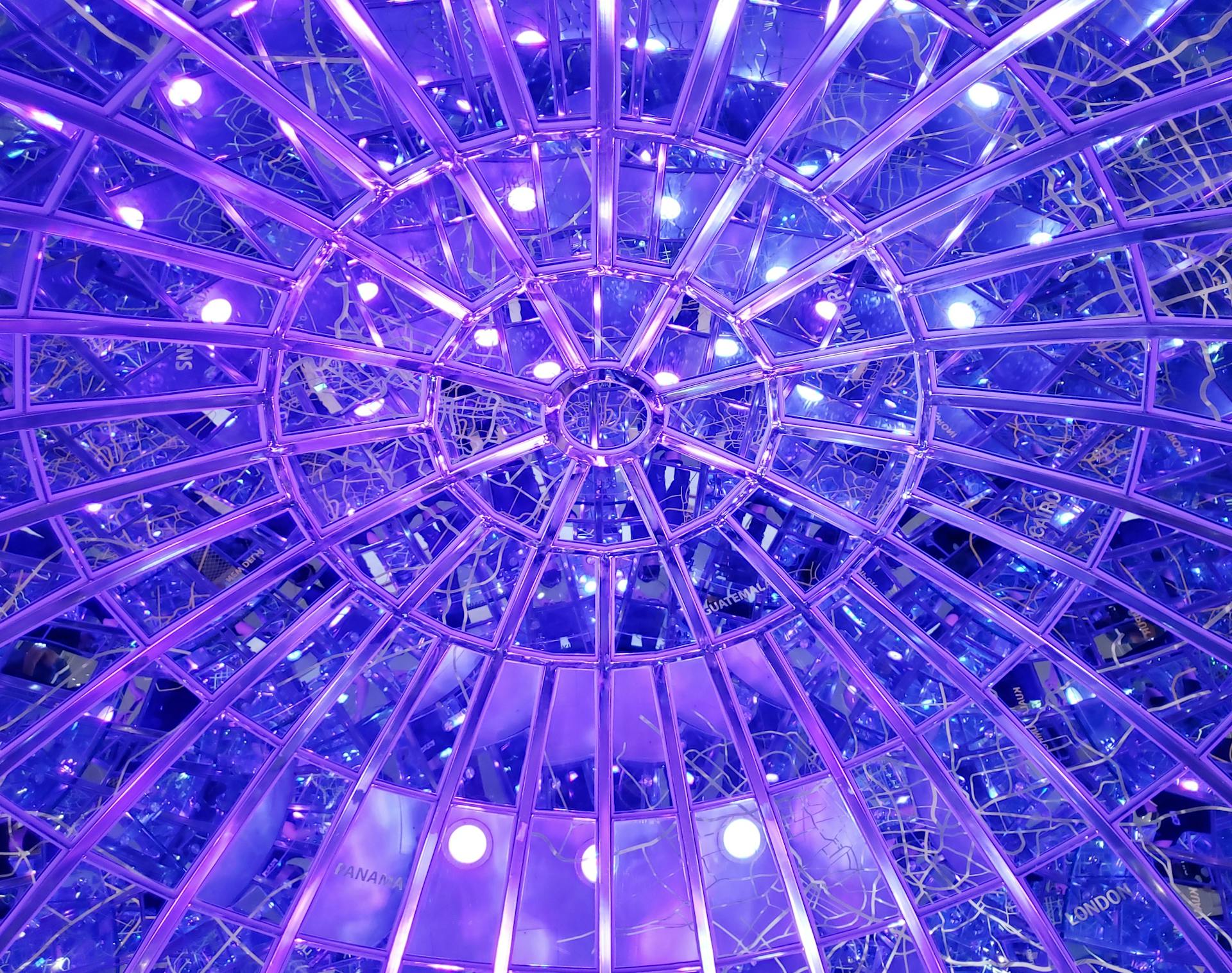 Vibrant purple ceiling of a geodesic dome with dynamic lighting and a modern design.