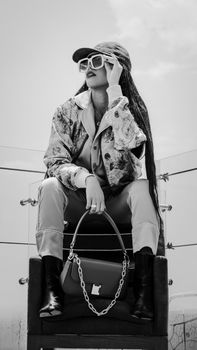 Black and white portrait of a stylish woman in urban fashion with sunglasses in Mexico City.