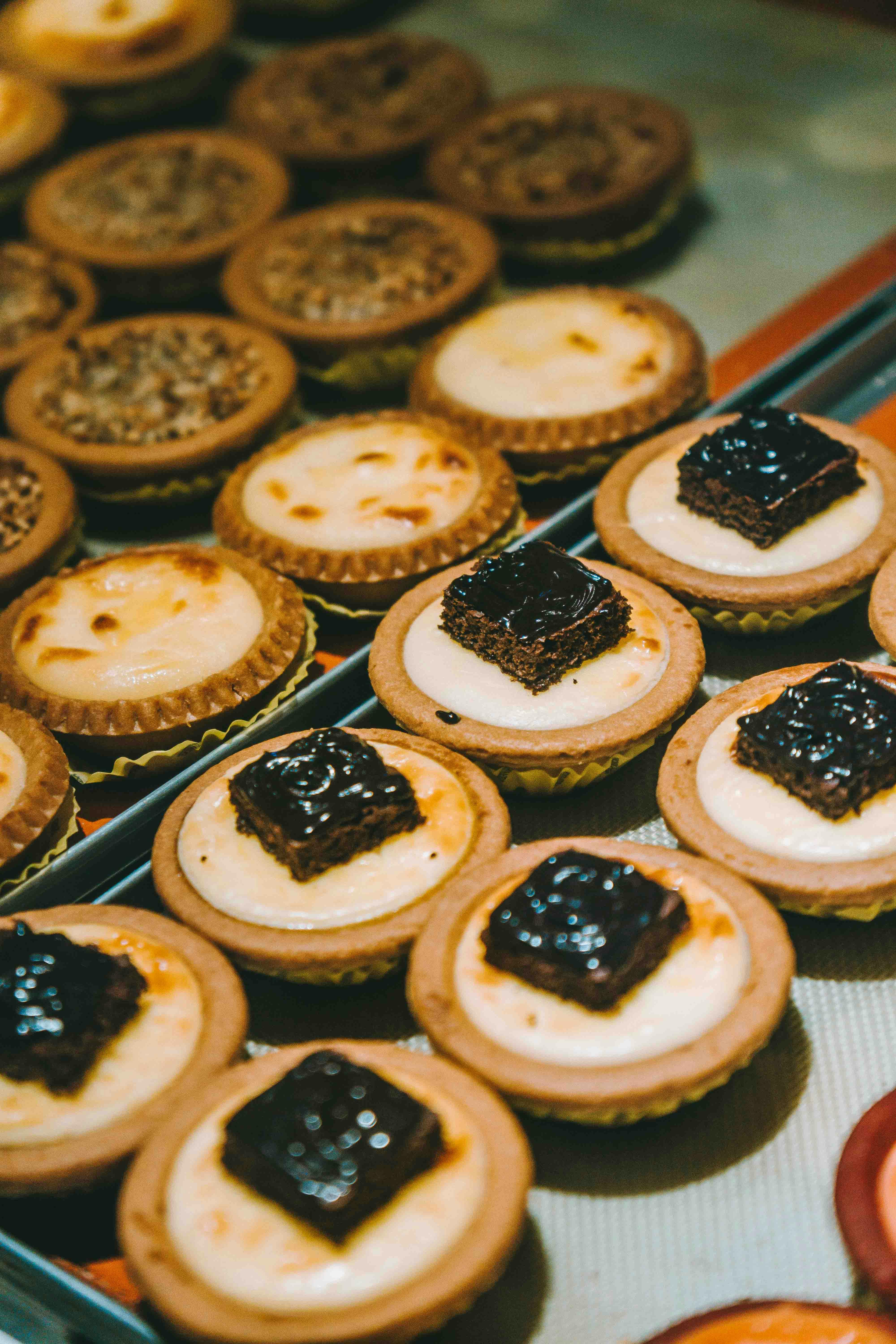 a tray of desserts with different flavors and toppings