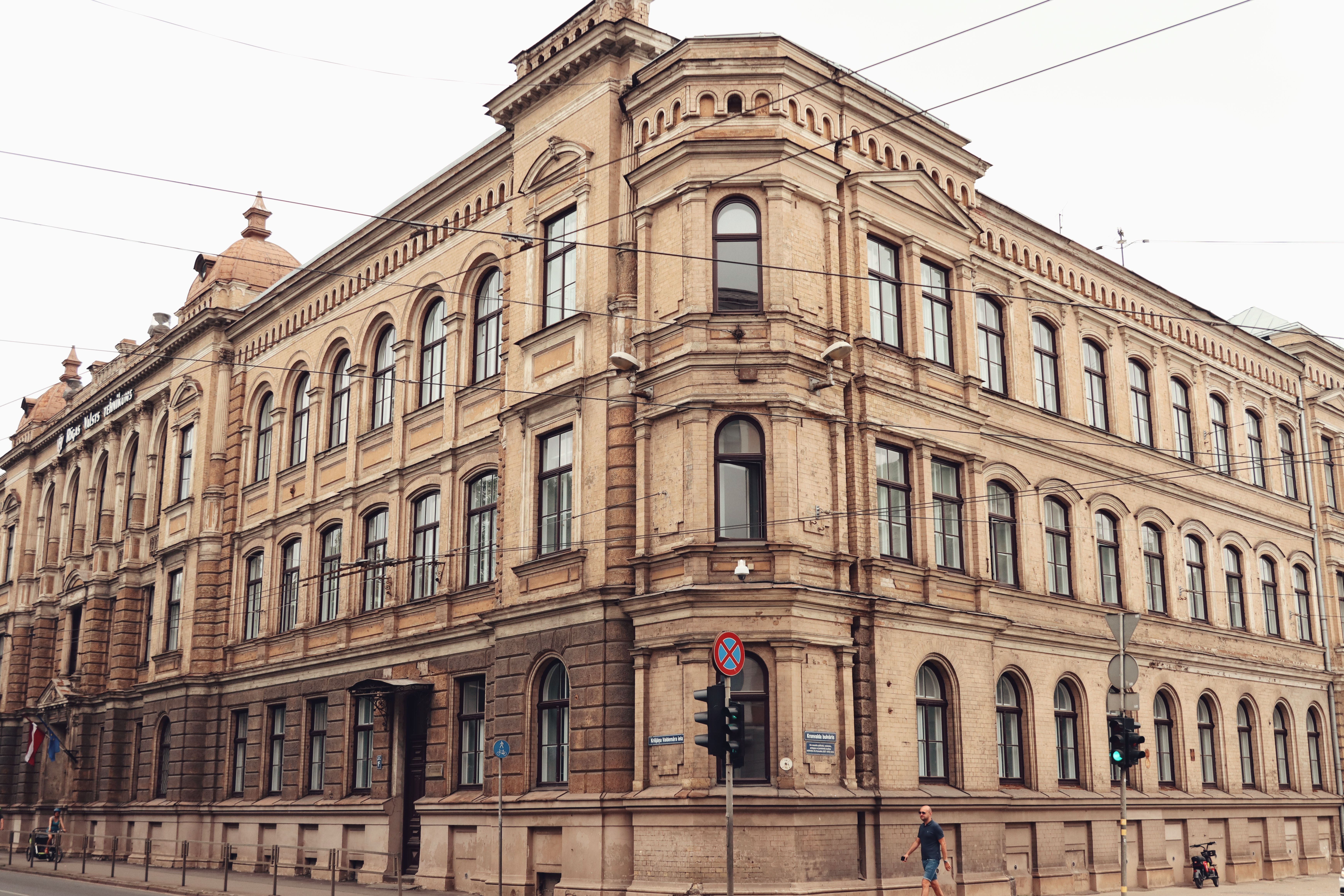 Historic brick building with arched windows on a street in Riga, Latvia