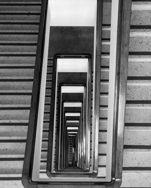 Free Black and white spiral staircase with geometric patterns and focus on railings. Stock Photo