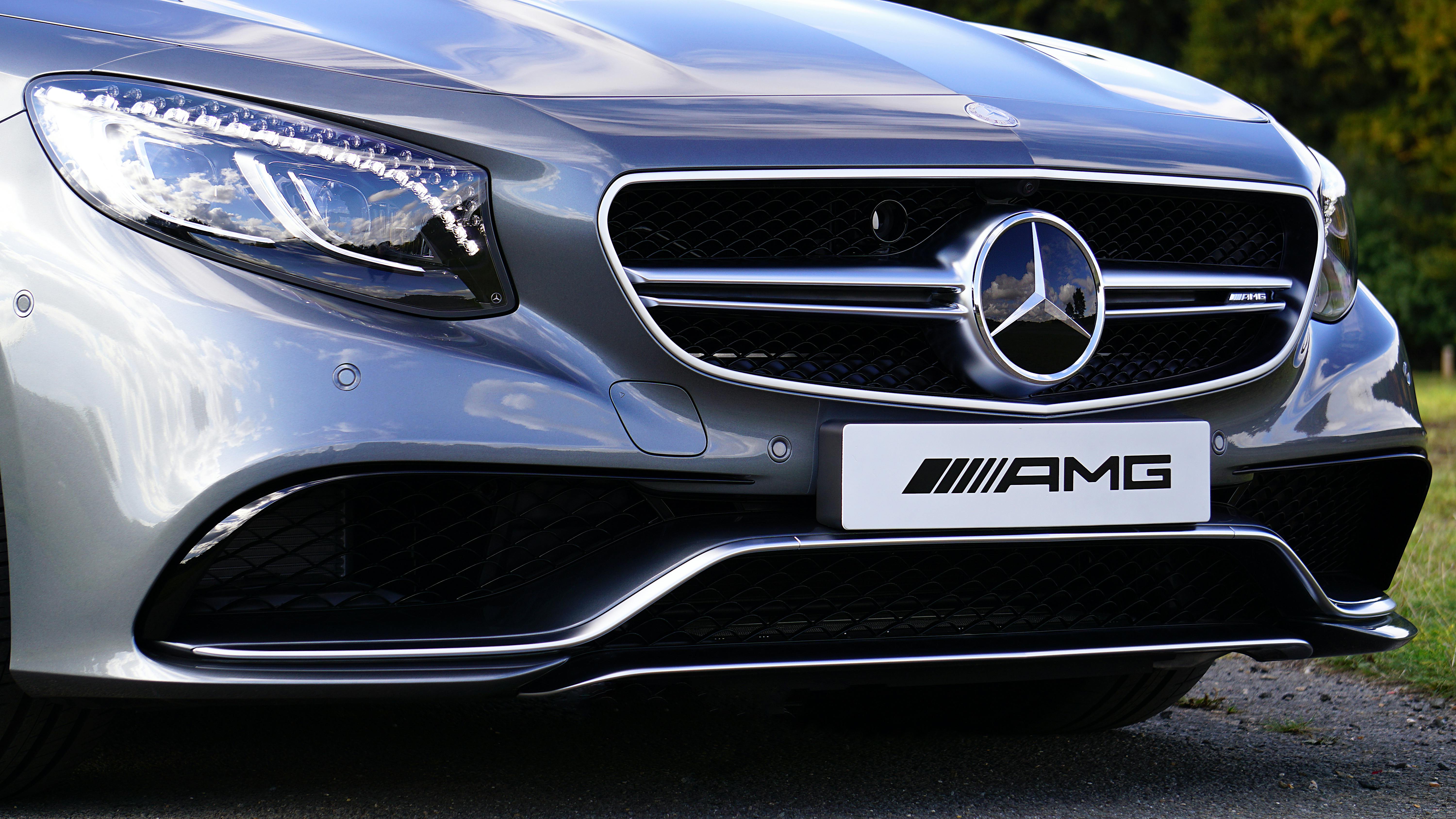 Detailed shot of a silver Mercedes-AMG S 63 showcasing the front grille and emblem.