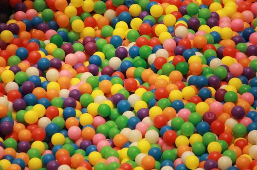 A lively assortment of colorful plastic balls in a playful heap, perfect for creative or fun settings.