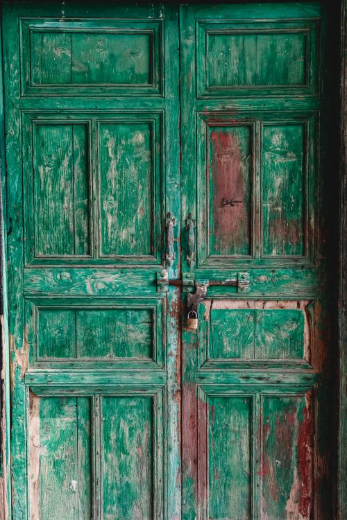 Free Close-up of a green vintage wooden door showcasing antique rustic details and texture. Stock Photo