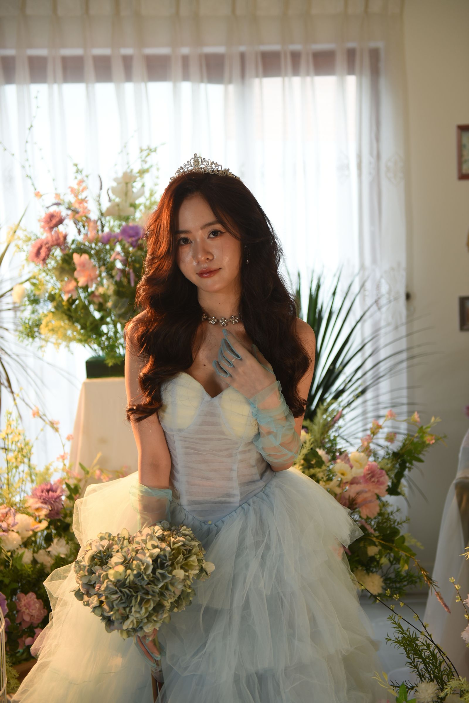 Woman in Blue Dress Sitting Posing with Flower Bouquet · Free Stock Photo