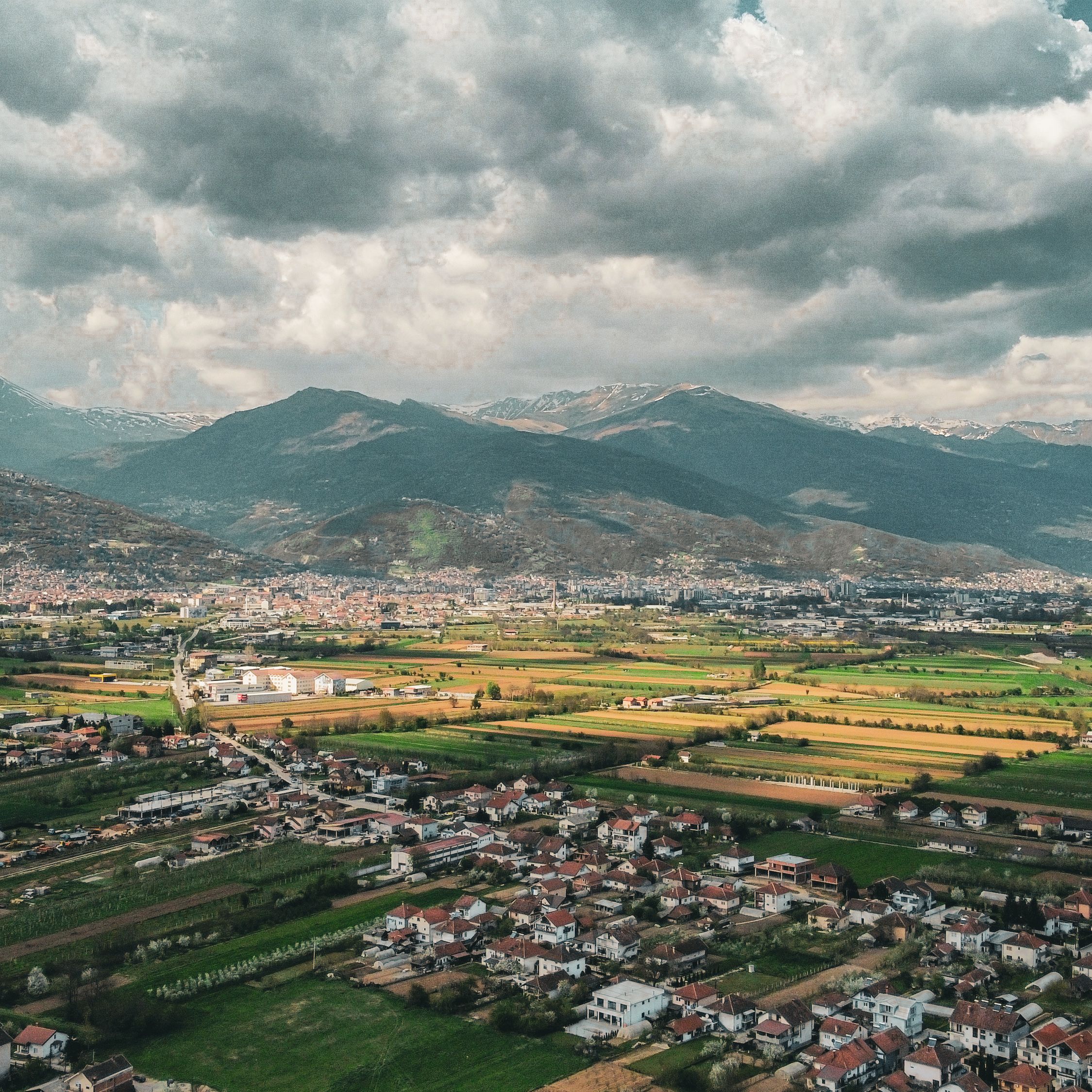 Valley town seen from a high ridge, photo by Jakov Jovanoski on Pexels