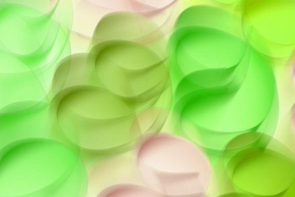 Vibrant abstract design with green and pink geometric shapes creating a futuristic visual pattern.