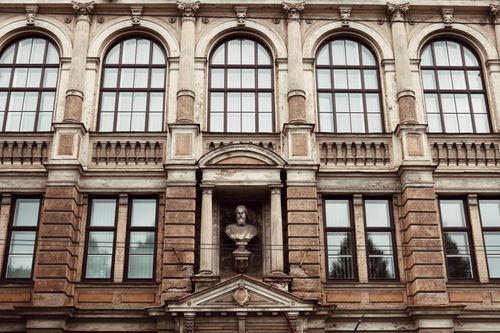 Free Elegant facade of a historic building in Riga with classical architectural elements. Stock Photo